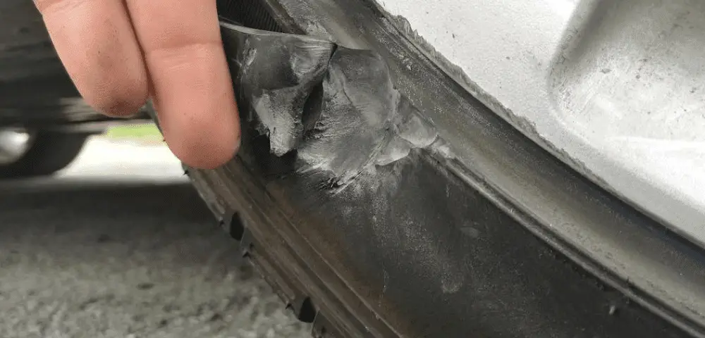 Man ripping a chunk of tire