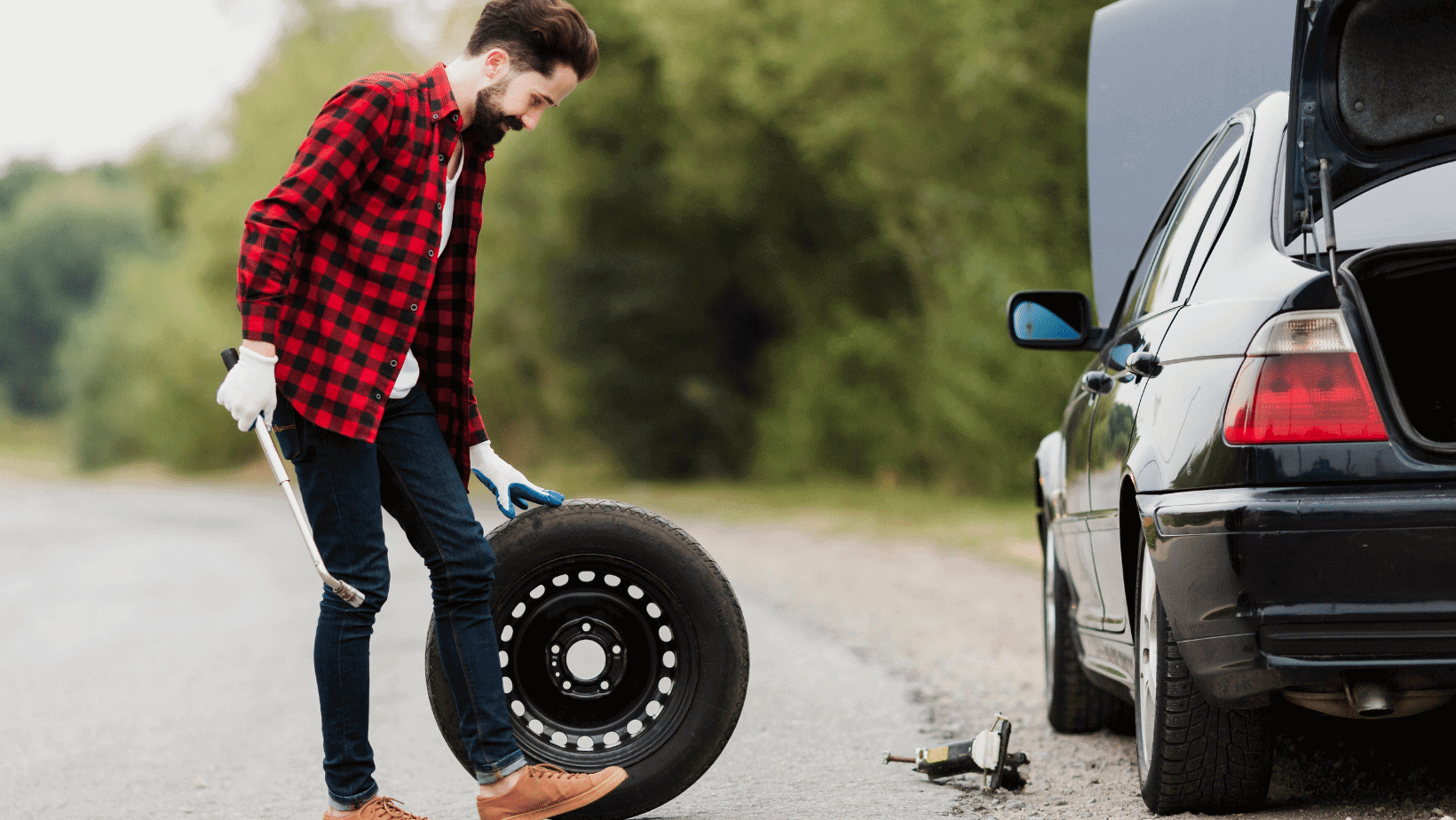 Man putting on a full size spare tire