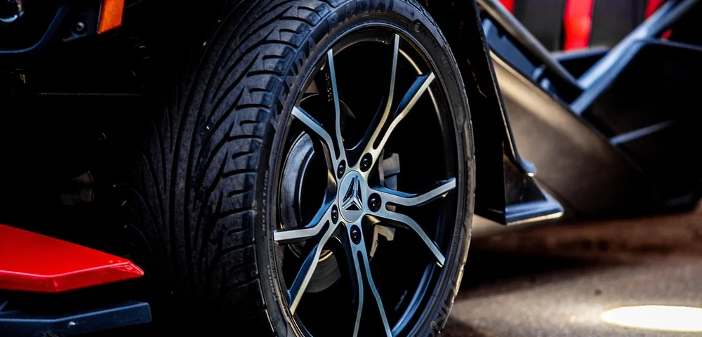 Close-up of a modern car's tire and alloy wheel with visible tread pattern