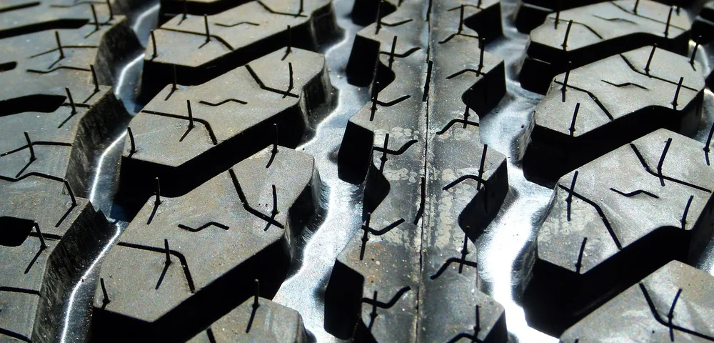 Close-up of a tire's tread pattern showing deep grooves and blocks