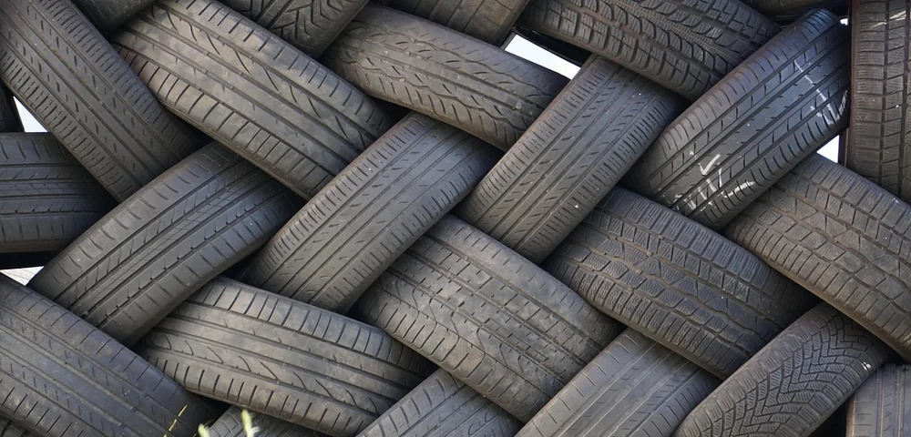 Close-up of multiple tire treads woven together showing detailed tread patterns