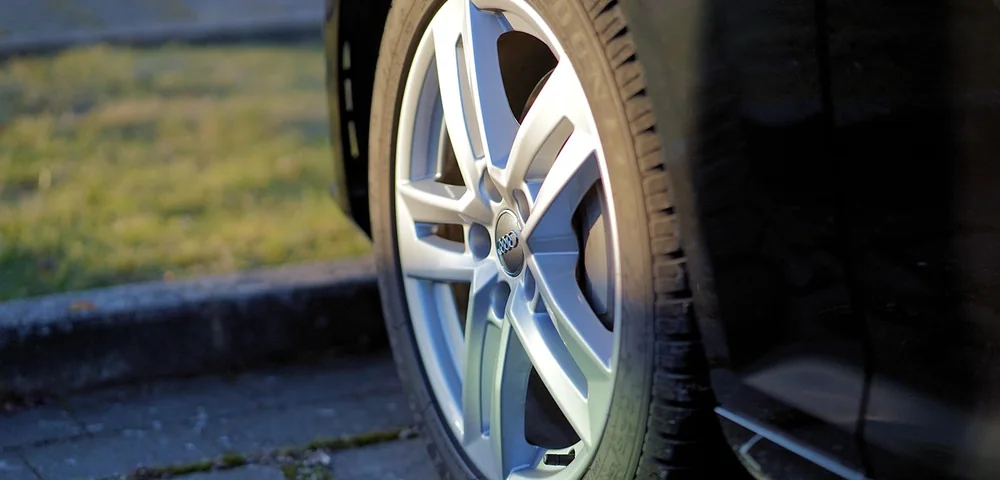 Close-up of a car's alloy wheel and tire showing tread detail and wheel design