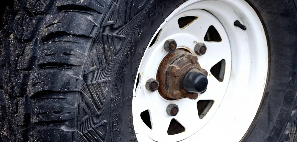 Close-up of a Kumho all-terrain tire mounted on a white spoke wheel