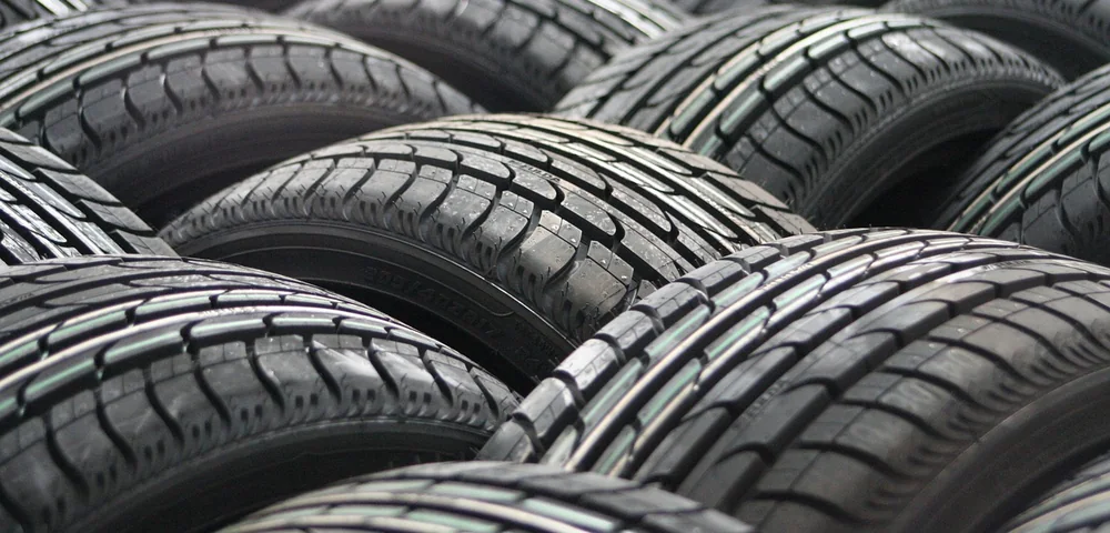 Close-up of several car tires showing detailed tread patterns